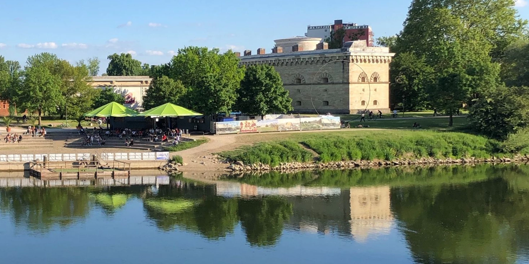 Ein Gebäude spiegelt sich im Wasser der Donau